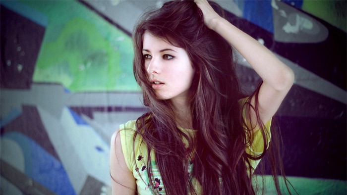 Model posing against graffiti wall