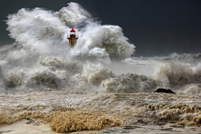 Lighthouse in a massive ocean storm wave
