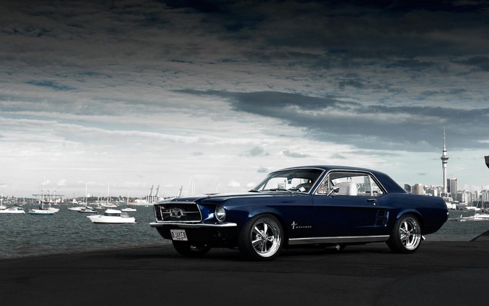 Blue 1967 Ford Mustang parked by the water