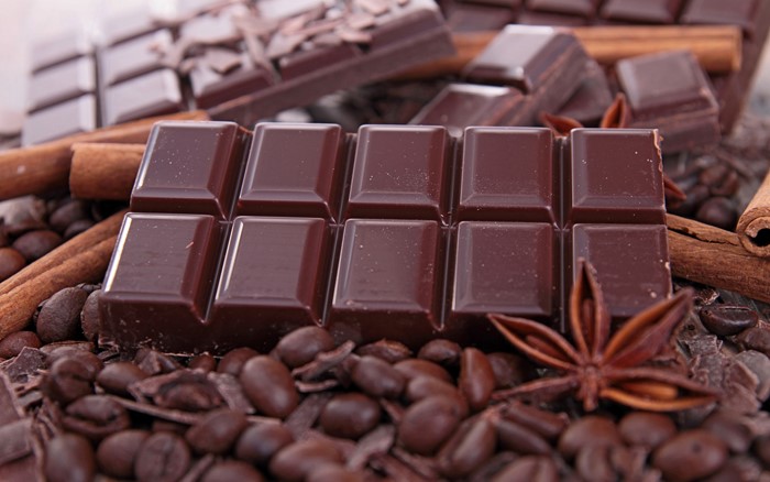 Dark chocolate bar with coffee beans and cinnamon