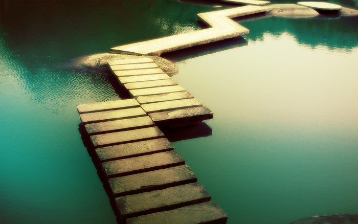 Wooden boardwalk over turquoise water