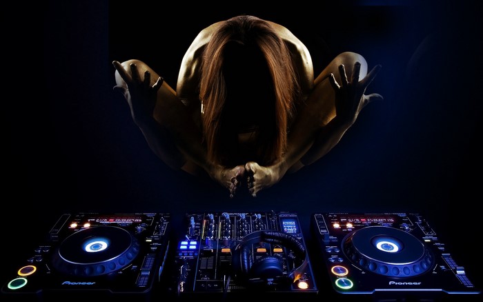DJ setup with a person in yoga pose
