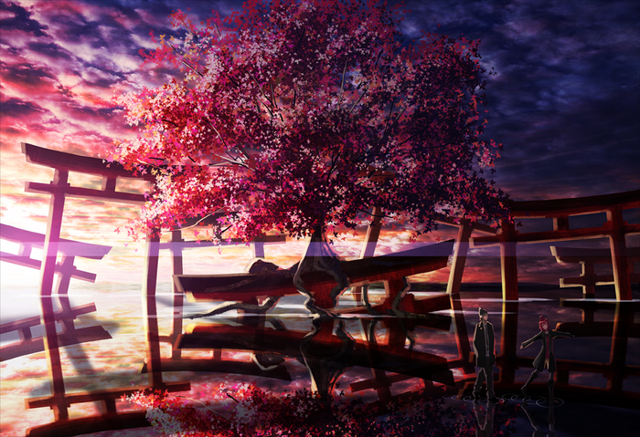 Sakura tree and torii gates reflected in water
