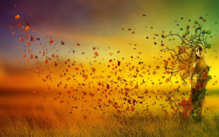 Woman with leaves and branches in a field