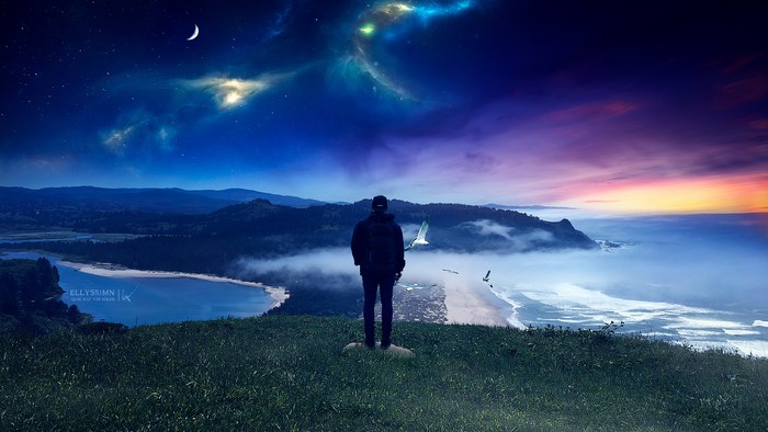 Man on cliff overlooking fantasy landscape at night and dawn