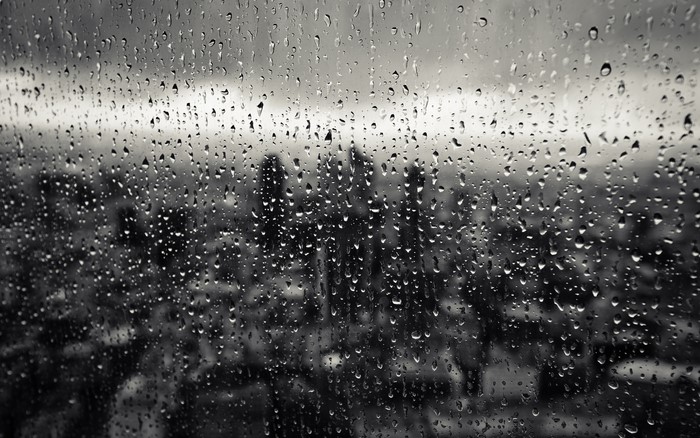 Raindrops on a Window Overlooking a Cityscape