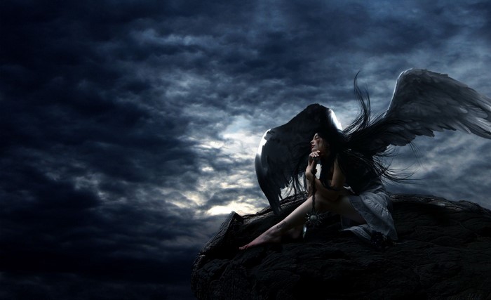 Dark Angel with Black Wings on a Cliff