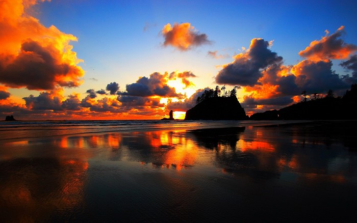Sunset over a beach with reflections