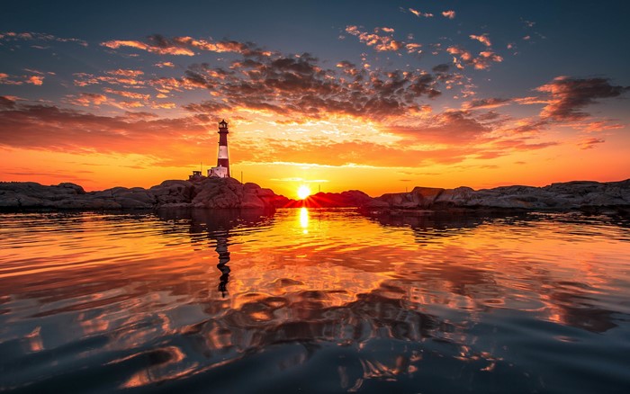 Lighthouse at sunset over the ocean