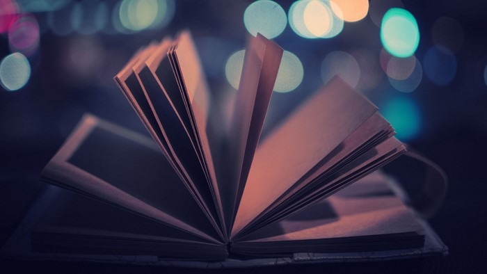 Open book with blurred lights in background