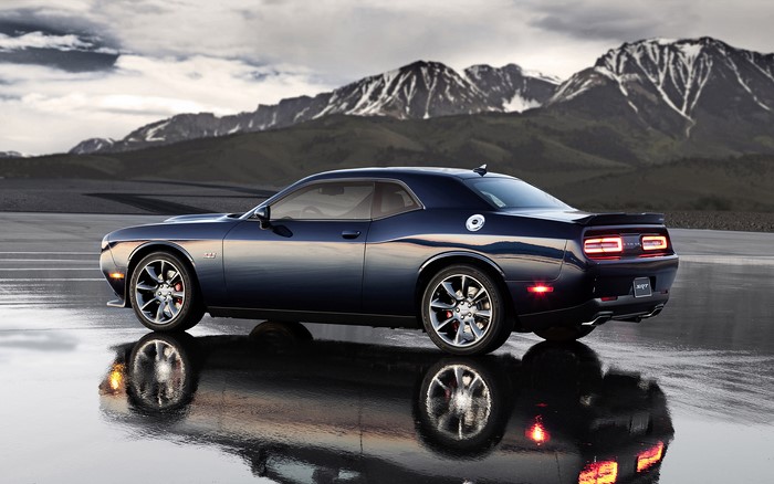 Dark Blue Dodge Challenger SRT on Wet Road with Mountains
