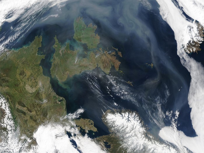 Satellite view of smoke plumes over land and sea