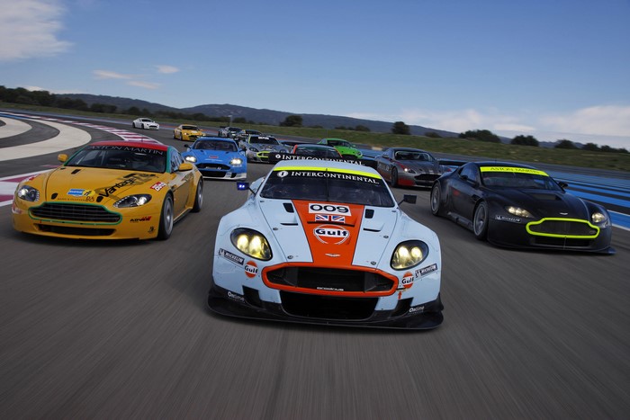 Aston Martin DBR9 race cars on a track