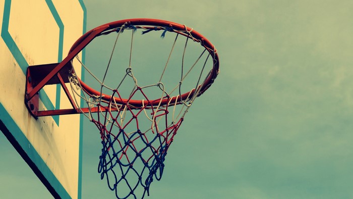 Basketball hoop and net against a cloudy sky