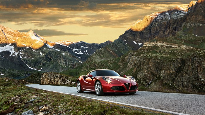 Red Alfa Romeo 4C driving on mountain road