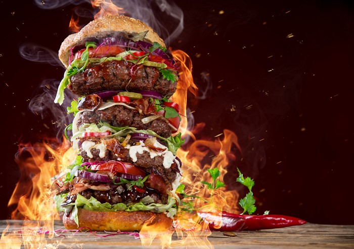 Giant flaming burger with chili peppers