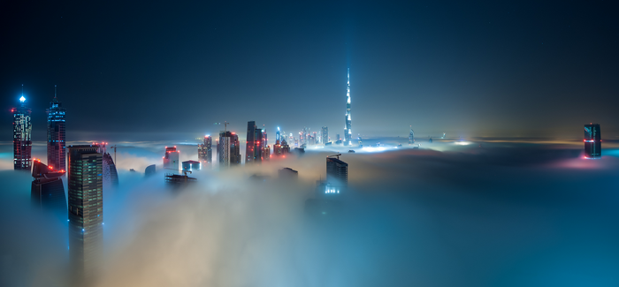 Dubai skyscrapers emerge from fog at night