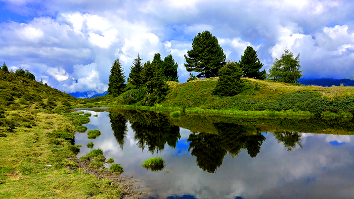 Lake reflection with trees and clouds