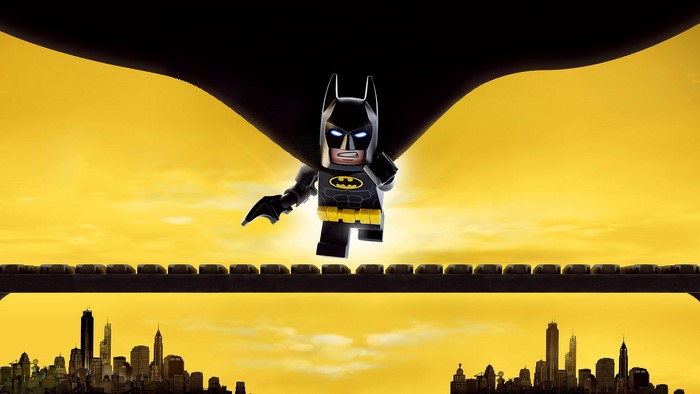 Lego Batman running on a bridge over a city