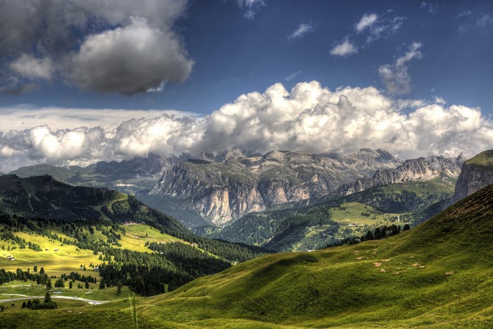 Green hills and mountains under a cloudy sky in Italy