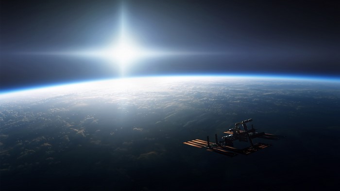 Space satellite orbiting Earth with bright sun