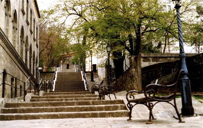 Stone staircase with benches and lampposts