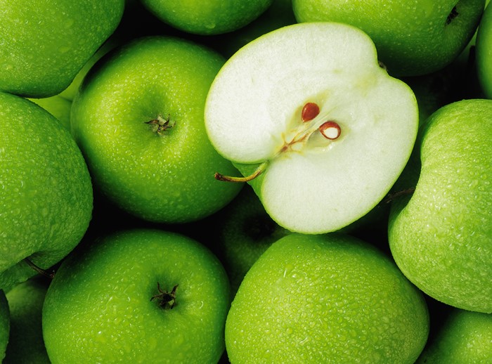 Green apples with one cut in half