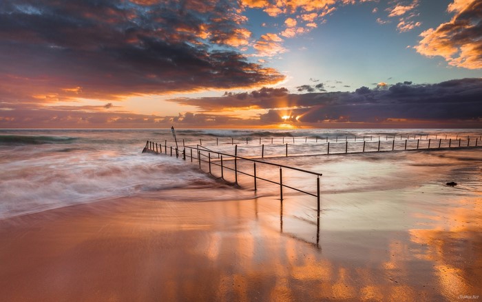 Ocean sunrise with tidal pool and waves