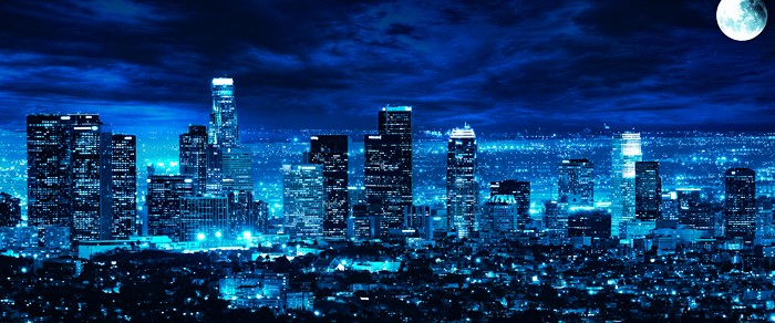 Blue Los Angeles cityscape at night with moon