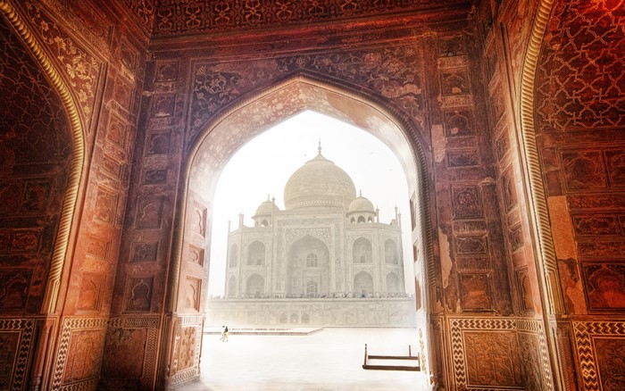 Taj Mahal through an ornate archway