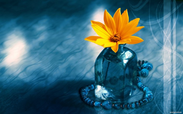 Yellow flower in a blue vase with blue beads