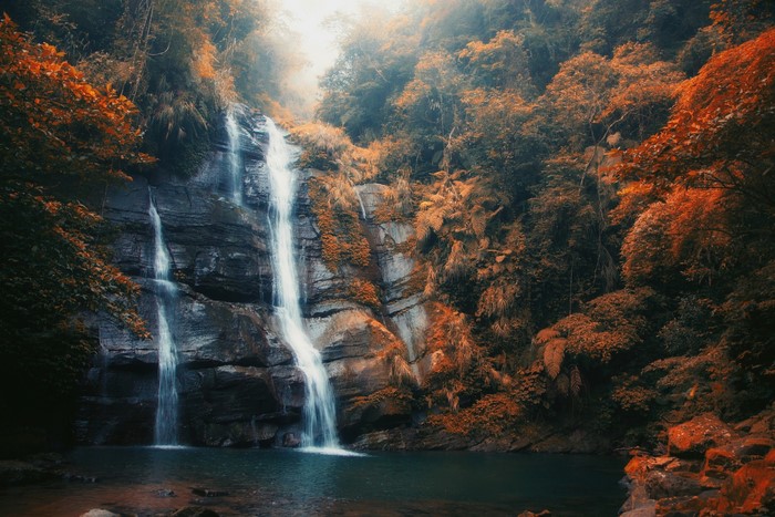 Waterfall in a forest with fall foliage