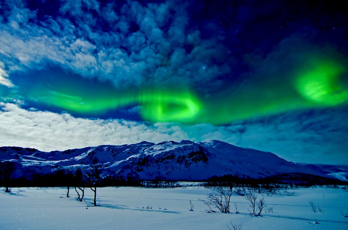 Aurora Borealis over snow-covered mountains