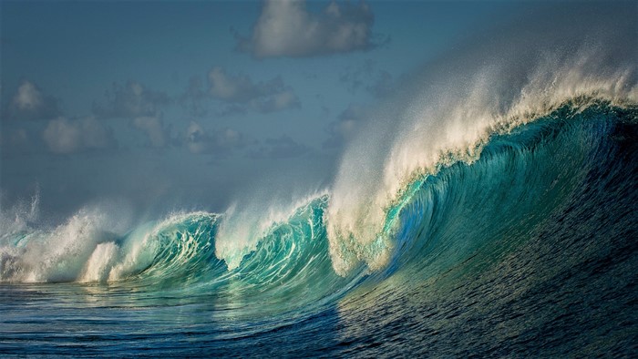 Turquoise ocean wave crashing