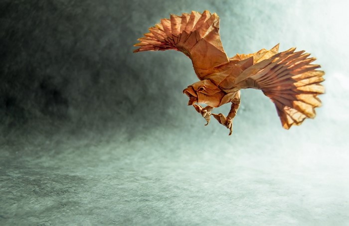 Origami bird in flight