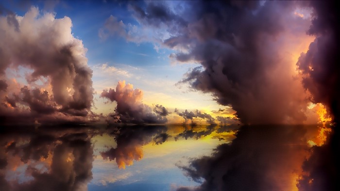 Dramatic sunset clouds reflected in water