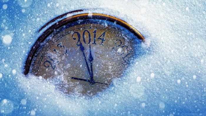 Clock covered in snow with the year 2014