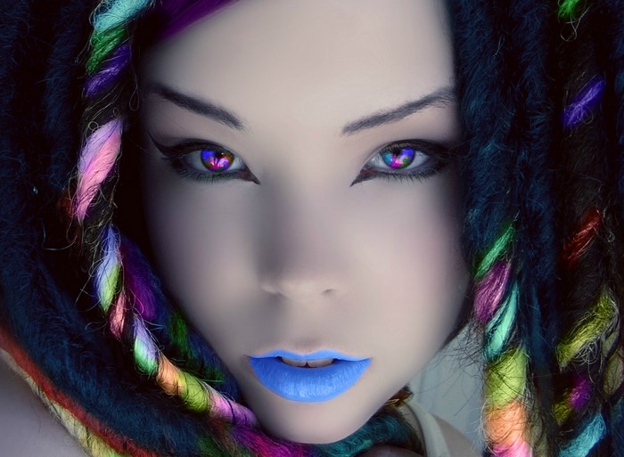 Woman with rainbow dreadlocks and colorful eyes