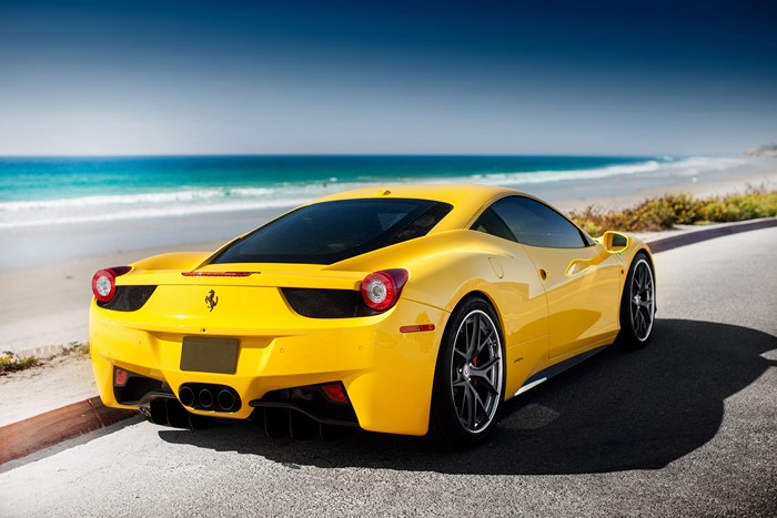 Yellow Ferrari 458 Italia parked by the ocean