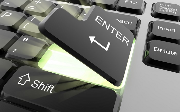 Close-up of a glowing Enter key on a keyboard