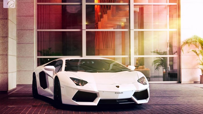 White Lamborghini Aventador LP700-4 parked outside building