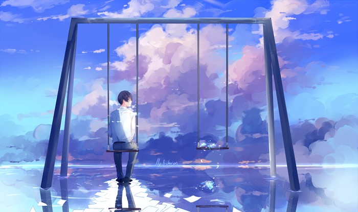 Boy on a swing overlooking a reflective sky