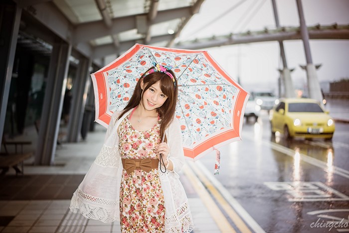 Asian woman with umbrella on a rainy day