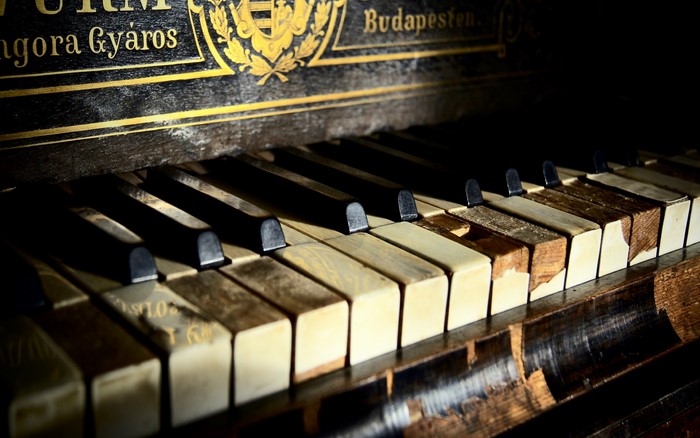 Antique Piano with Damaged Keys in Budapest