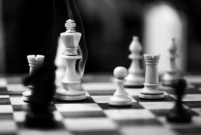 Black and white chess game with smoke