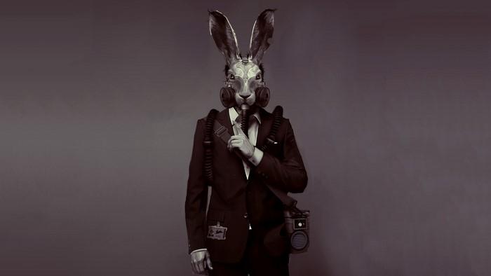 Man in suit with rabbit gas mask from Deceit