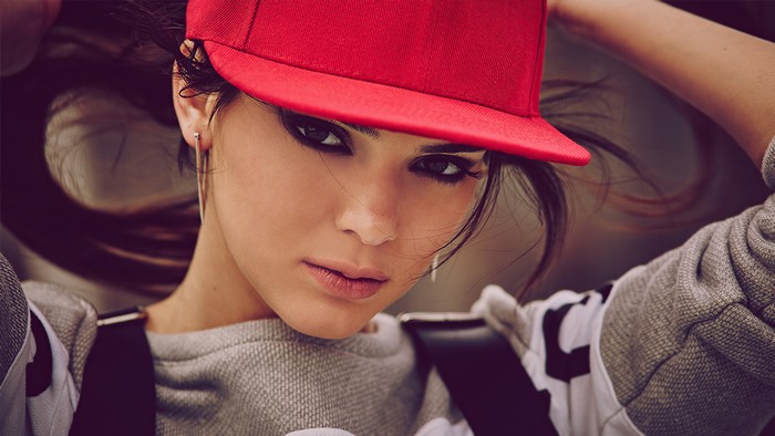 Kendall Jenner wearing a red cap