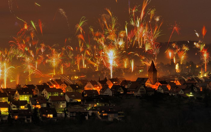 Fireworks over a town at night