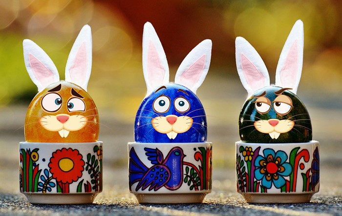 Easter eggs with bunny ears in decorated cups