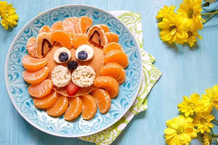 Lion-shaped pancake breakfast with fruit